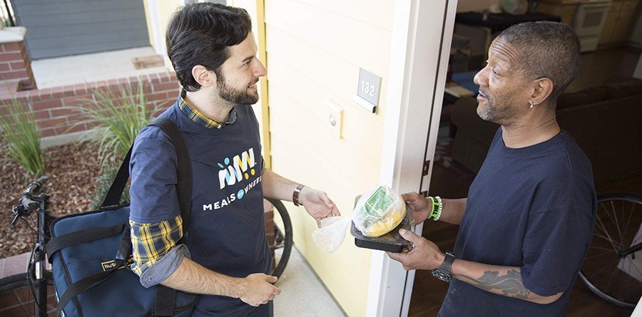 photo of a Meals on Wheels food delivery to a person at home